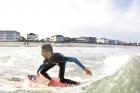 Fifteen-year-old Addison Miles prepares for a trick in the surf at 13th Avenue South in Surfside Beach.