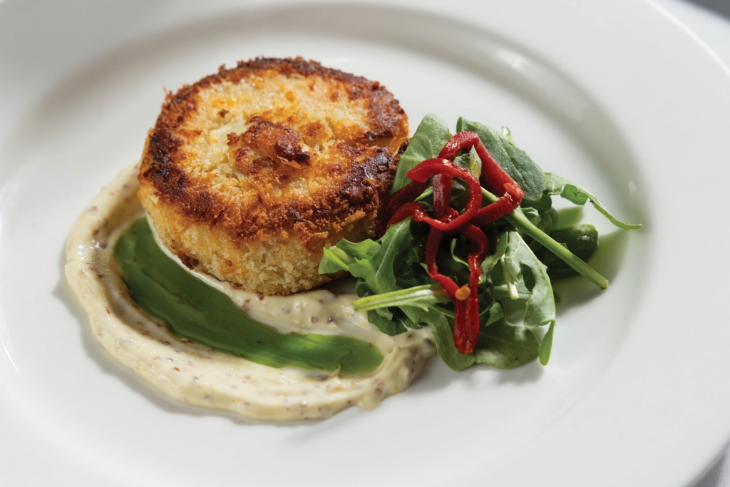 The Jumbo Lump Crabcake, nestled in a house-made mustard aioli is a true crowd pleaser