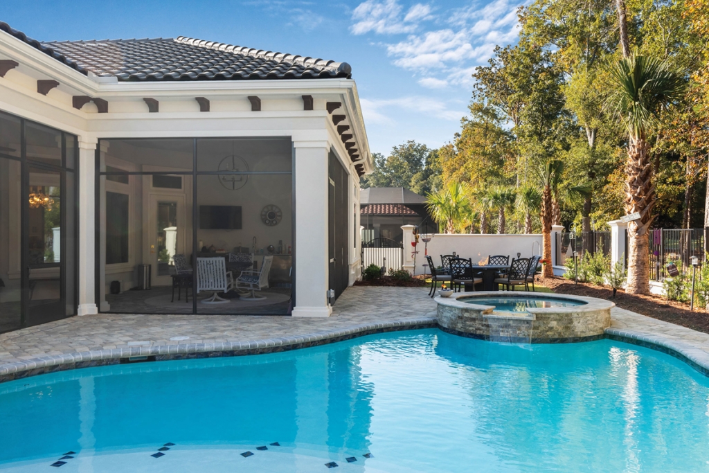 Phil and Elaine Saccente, left, pose in their outdoor pool oasis, where they love to escape on downtime for a taste of outdoor living.