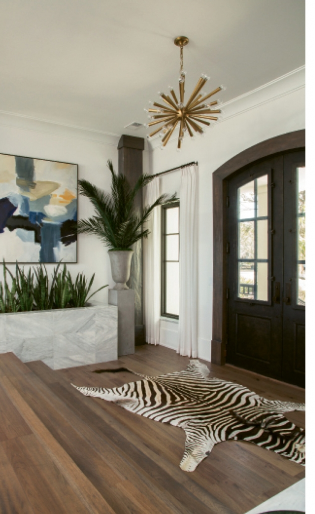 Nature comes inside with green-inspired design elements like indoor planters, driftwood accessories and even “Casper,” the zebra rug.