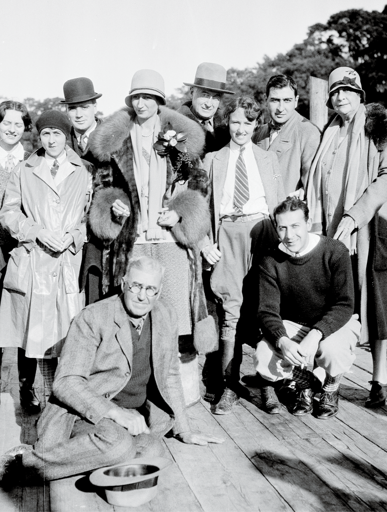 Belle (pictured in fur coat and hat) with family and friends on the Hobcaw dock in 1935.