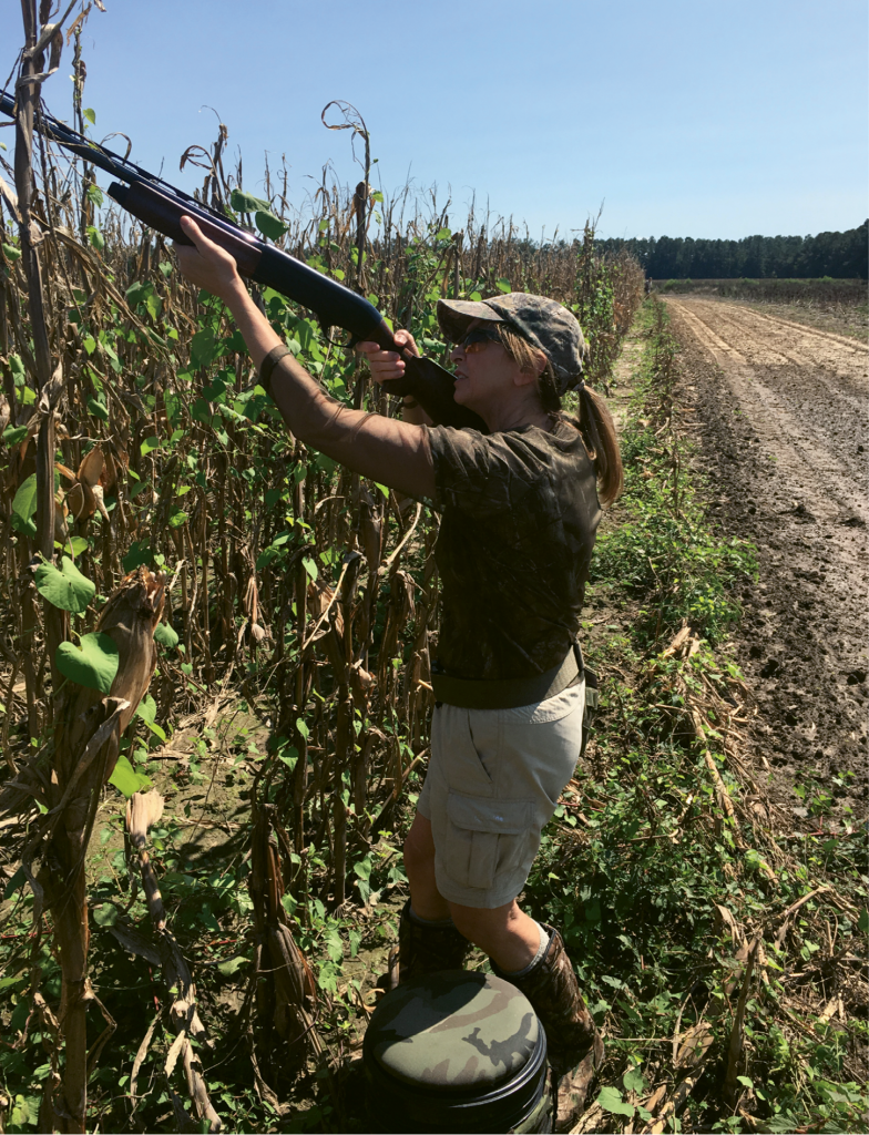 Boineau takes aim while dove hunting at Honey Camp Dove Club.
