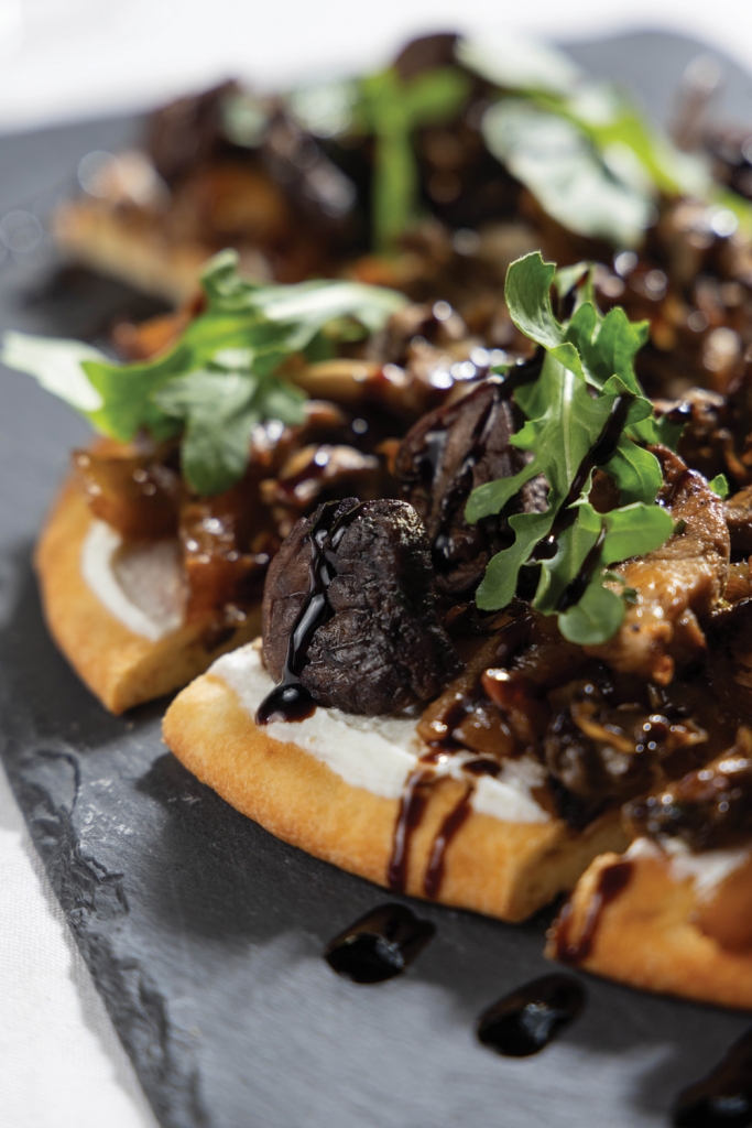Wild mushroom flatbread served with caramelized onion, truffled ricotta, arugula and balsamic glaze