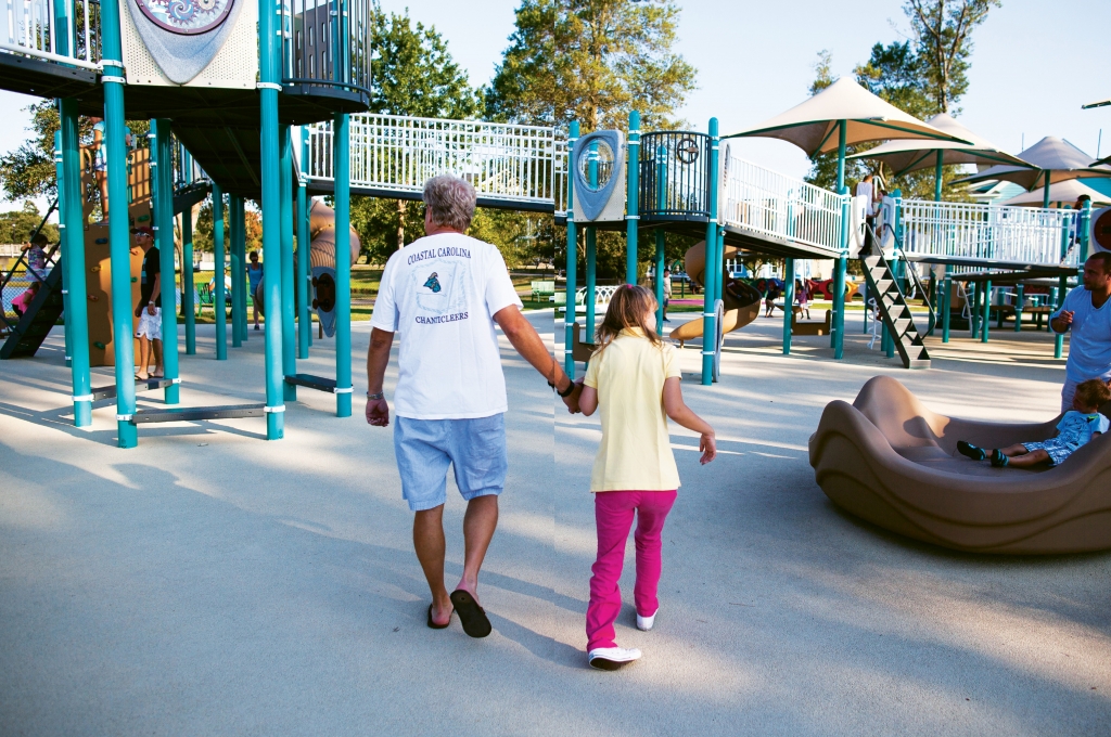 Savannah Thompson and her father, Lance, check out the playground facilities, which rubberized surfaces, plenty of shade and specially engineered equipment designed for special needs and able-bodied children to use together.