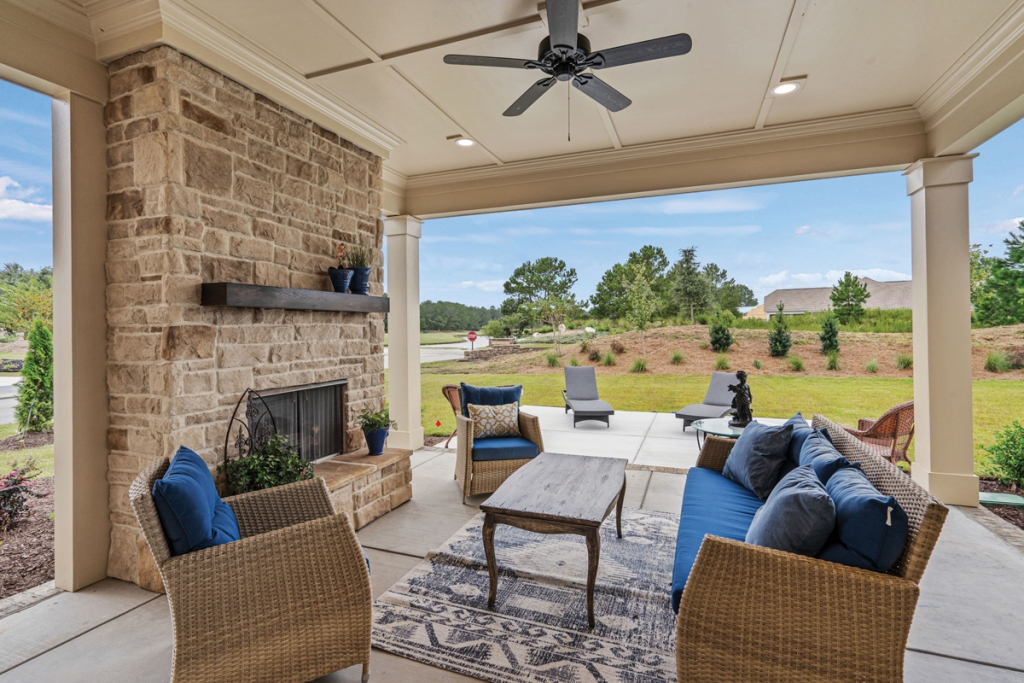 The outdoor living space featuring a cozy fireplace.