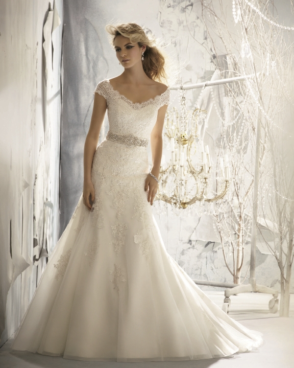Mori Lee: Delicate Alencon lace on net highlights this beautiful gown that includes  a removable crystal-beaded satin belt.  Style 1960. Fancy Frocks, $1,323