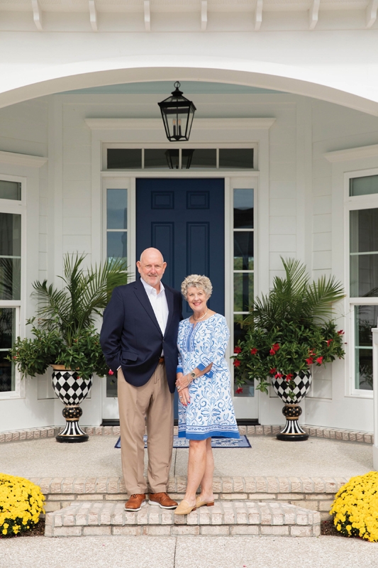 Sam and Lisa Kinon pose in front of their showstopping, custom new-build home.