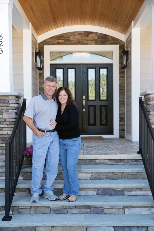 Elly Brundage, who poses with husband Billy, wanted her Ocean Isle Beach home to feel like a welcoming embrace and a spa at the beach, complete with a sea glass paint shade on the walls.