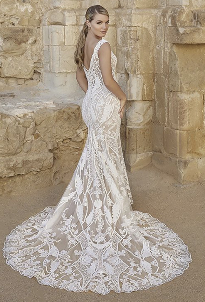 Angie by Casablanca Bridal Romance and femininity is found in Style 2461 Angie, featuring a classic fit and flare silhouette that flows into a 76-inch train. The most divine Bohemian cotton lace swims in alternating floral and geometric patterns for an ultra-unique look. Amanda’s Collection, price available upon request.