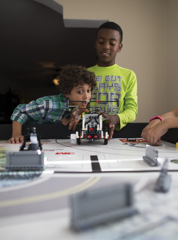The First LEGO League is all about the fun of learning S.T.E.M. (Science, Technology, Engineering, Math). Here, Trent Toole and Jayden Johnson prepare to launch their robot on the game board.