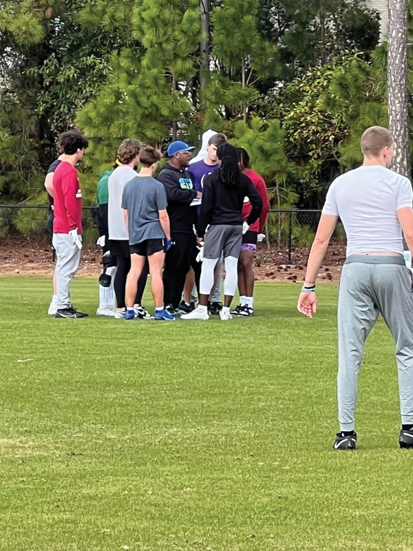 Butler coaches members of the 7 on 7 traveling football team.