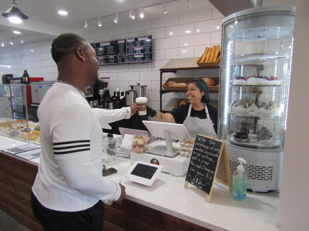 Butler receives his daily morning coffee from Aiskel Garcia at Le Manna Bread in Myrtle Beach.