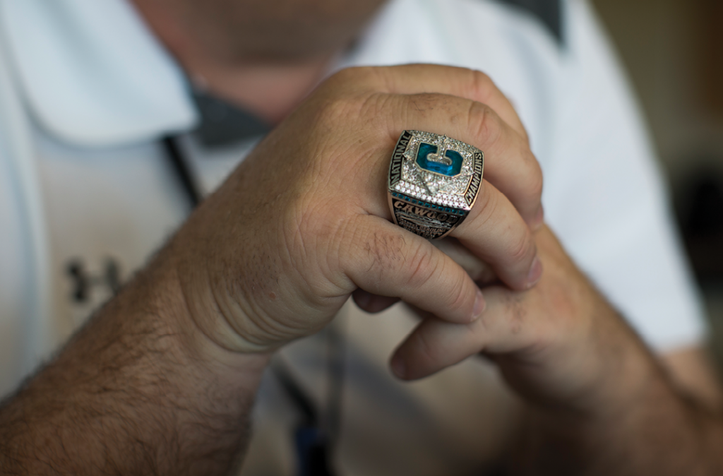 Assistant Athletics Director Mike Cawood wears his CCU championship ring while watching pre-game activities from the press box