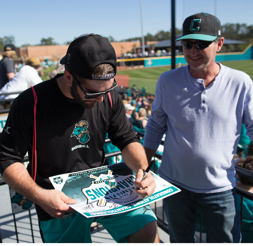 Anthony Marks signs an autograph for a CCU fan.