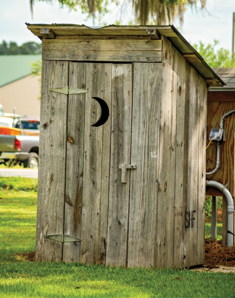 Cleaning Up, Reconstructing:  Dennis Reynolds and Bo Turbeville constructed an outhouse from lumber found around the area.