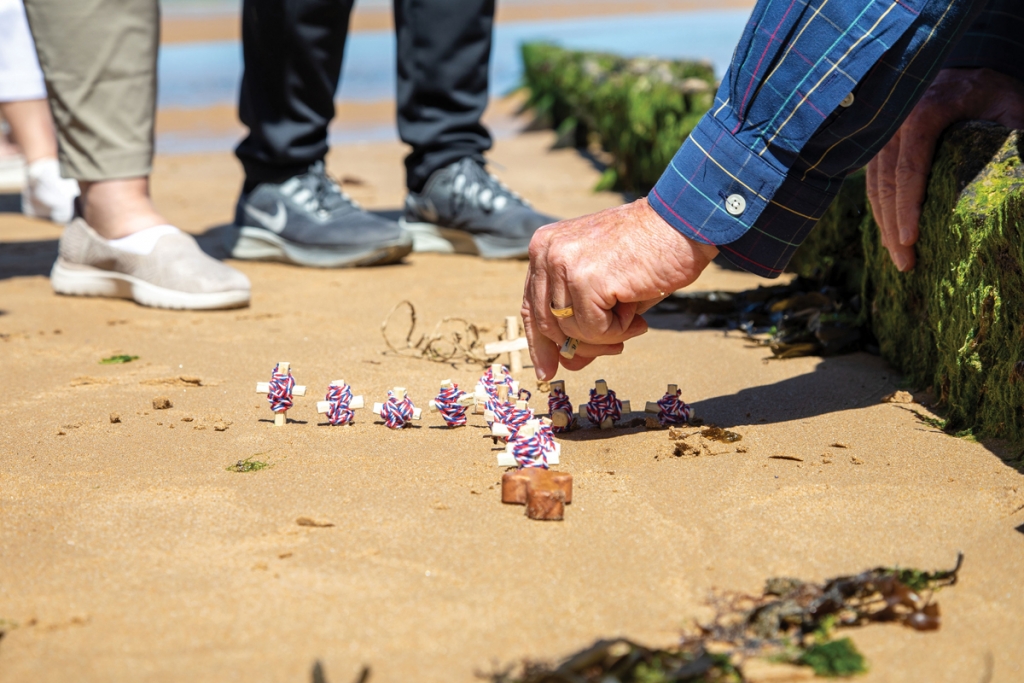 Band members placed memorial crosses in the sands of Omaha Beach.