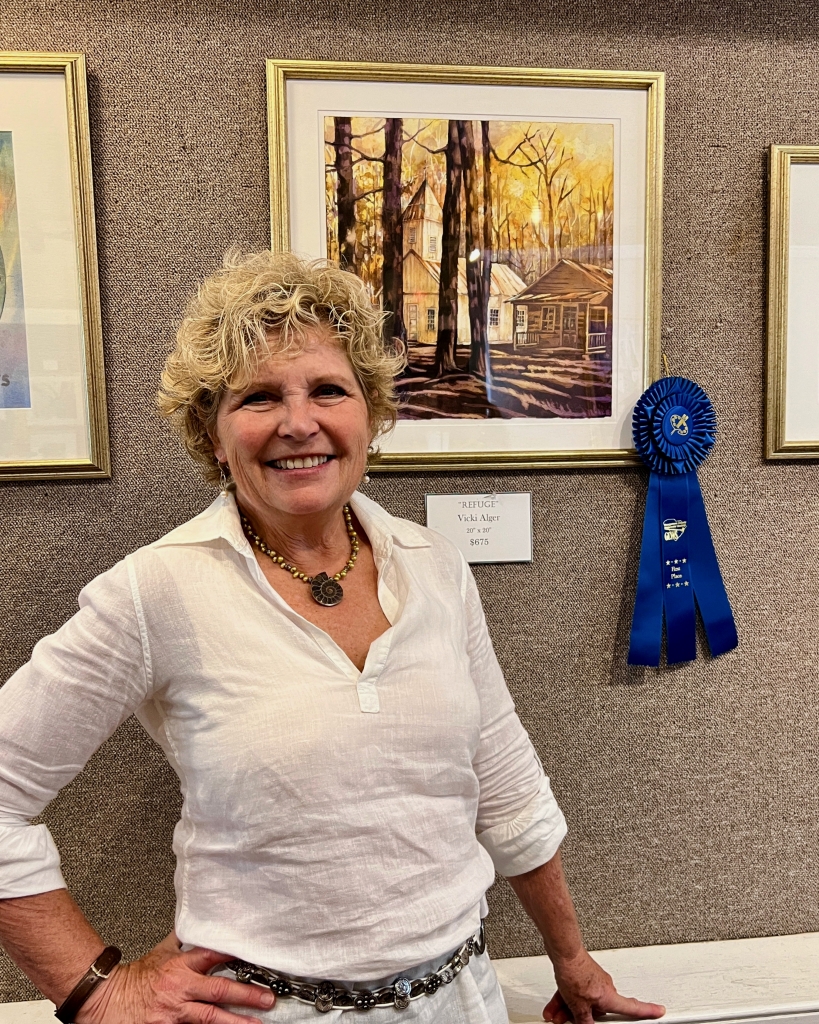 The artist with a first-place ribbon for “Refiuge.”