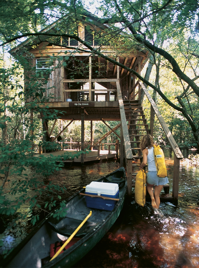 Treehouses accommodate two to eight guests and are constructed with locally harvested materials.