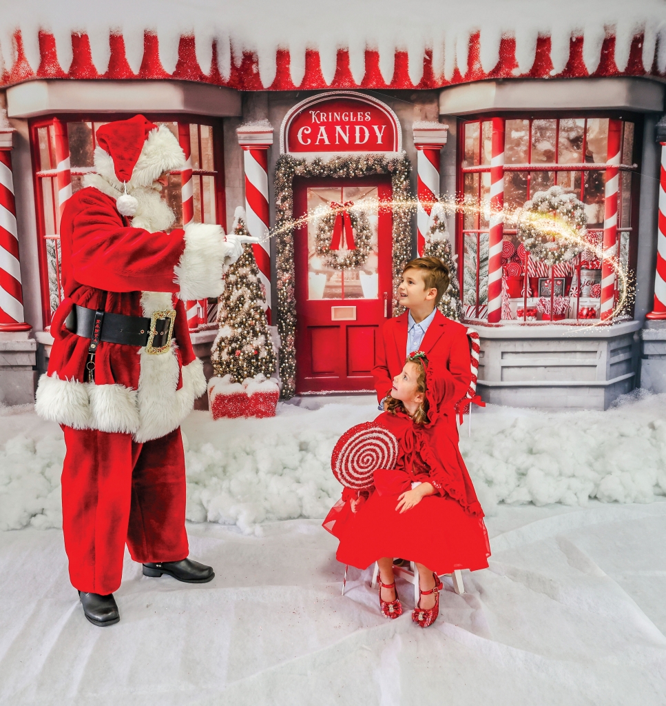 Santa Claus is magical and kids know that. Harry Woodbury, aka Santa Harry, elicits a sense of wonder in the faces of two children at a photo shoot by Kellie Sams of Sams Photography.