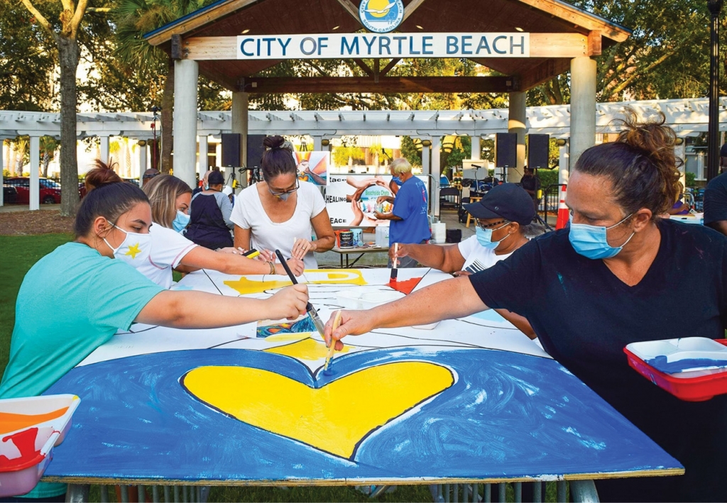 Community members contribute to the creation of the mural at one Beachside Chats session.