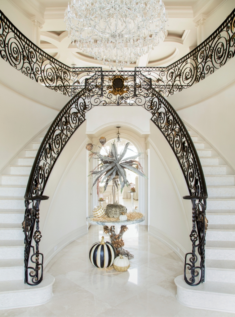 Stairway To Heaven: Making for a movie star grand entrance, the foyer features a double wrought iron staircase with Mother-of-Pearl risers, lit by lofty windows and a shimmering chandelier.