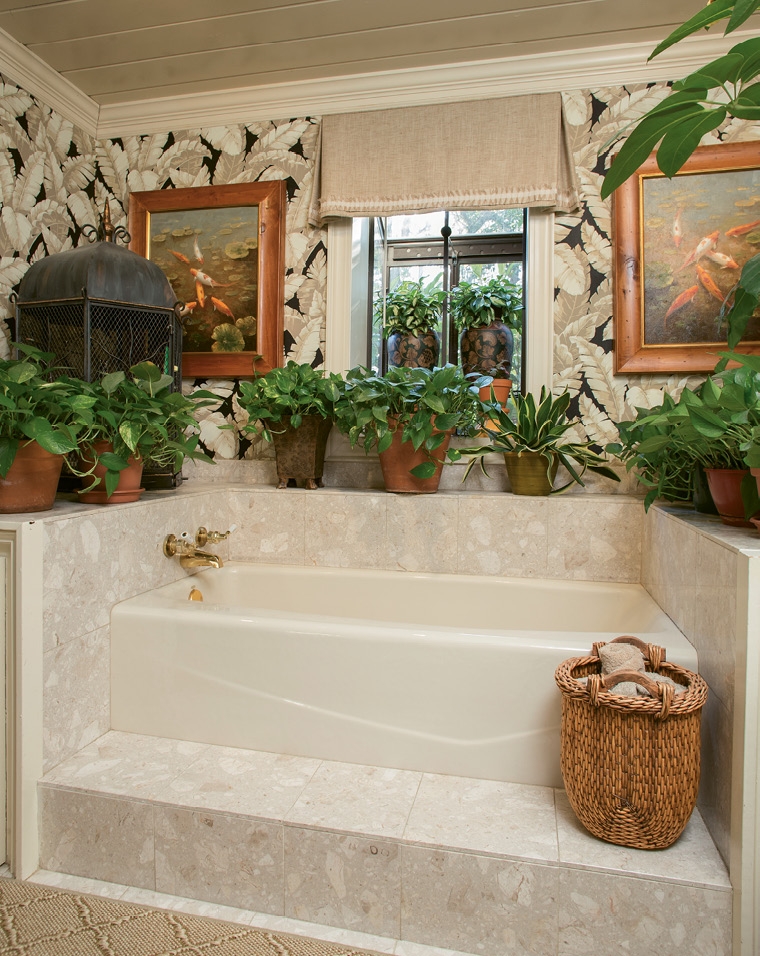 A soaking tub communes with the natural elements of live plants and parakeets