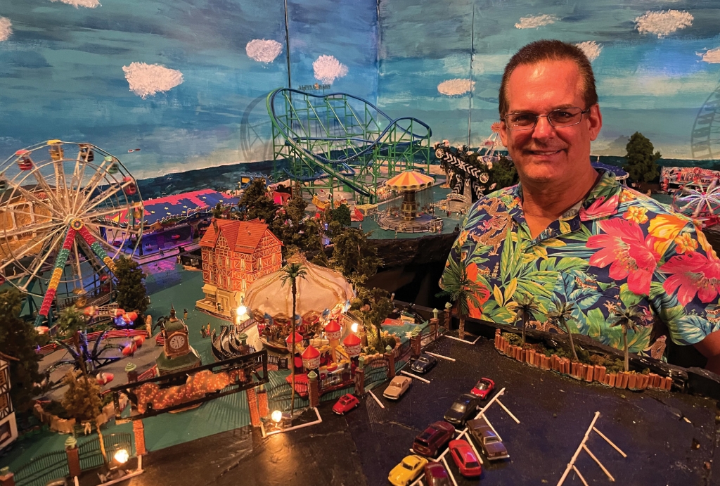 Ken McMichael is surrounded by a miniature version of The Myrtle Beach Pavilion Amusement Park he created in his house off Kings Highway.