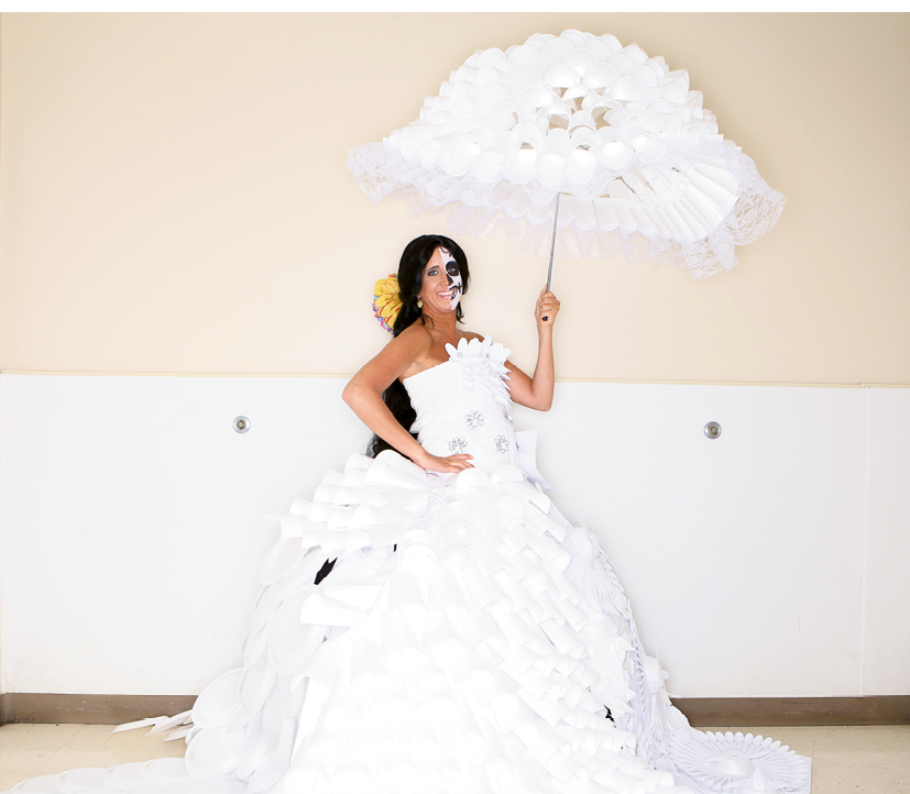 Most Creative Award  Designers: Southern Belles of Miller-Motte Technical College  Sponsoring company: Miller-Motte Technical College  Model: Christina Capo  Description of outfit: The name of this fashion is “Dia de los muertos wedding dress.” Materials used include paper; Styrofoam cups, plates and bowls; plastic forks and spoons; lace; pop tabs; metal wire; tissue paper; doilies; plastic wrap; twine and hot glue.