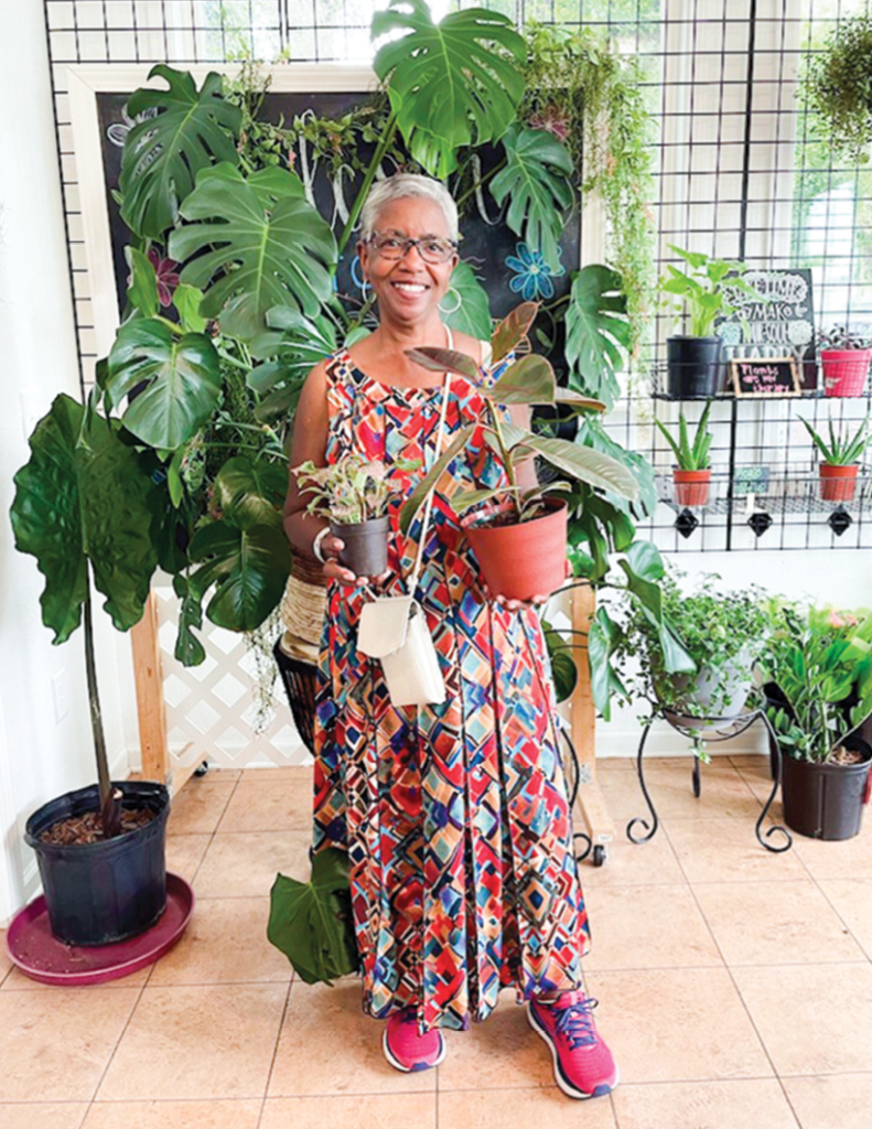 Cheryl Adamson, founder of CHOPS, enjoys the lush greenery  in Plant Oasis.
