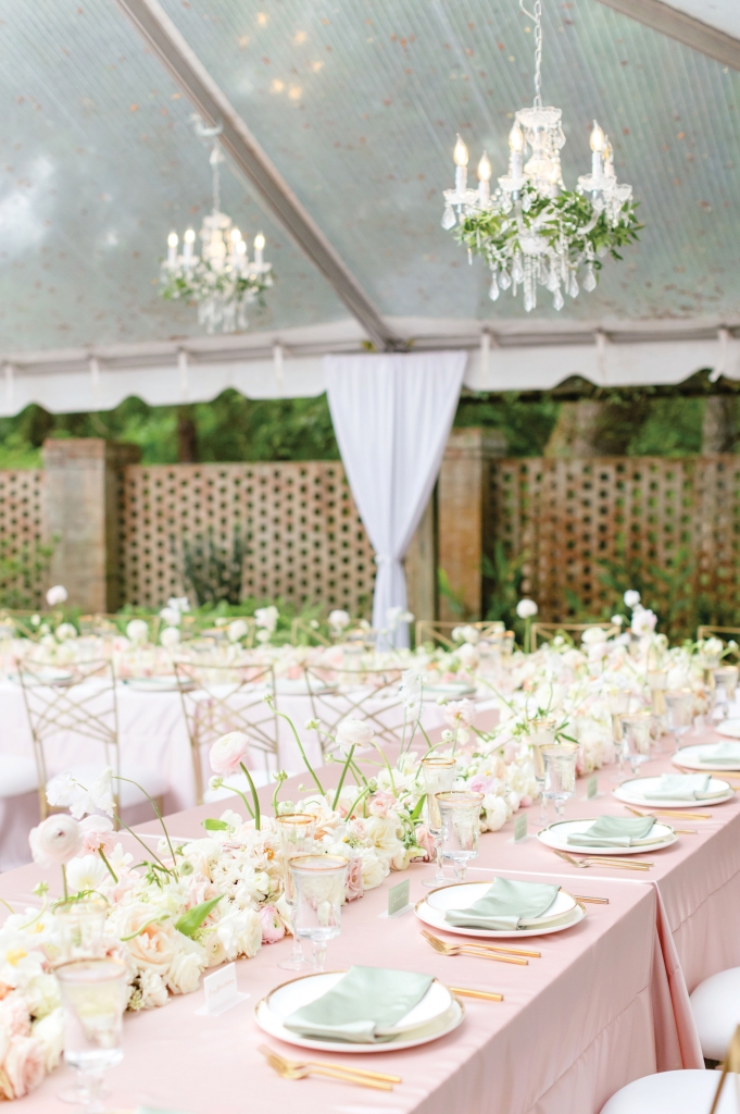 Picture Perfect:  A full floral runner was draped in the center of the U-shaped table and cascaded down to the historic brick courtyard of the Holliday Cottage.