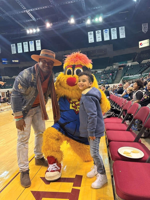 Butler with son Jonah at a Cleveland Charge G league pro basketball game.