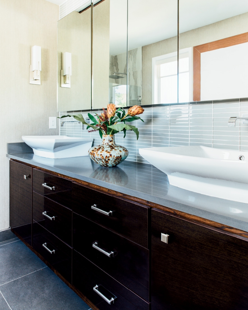Every bathroom in the Warren house is a work of art. Gleaming wood, mix-and-match tile work and glossy white in cabinets and vessel sinks make these private spaces smart and sleek.