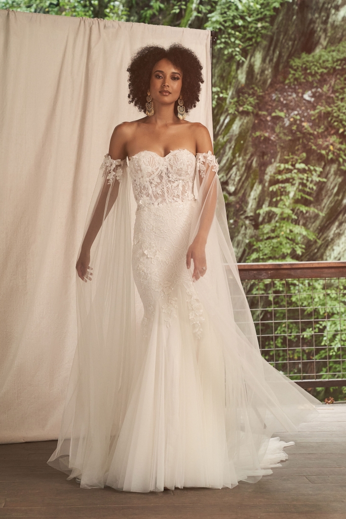 Lillian West  Allover lace fit and flare with sheer bodice and exposed boning. Gown adorned with tonal beaded and sequined lace appliques with 3D lace appliques scattered over top. Paired with detachable off the shoulder sleeves. The Little White Dress Bridal Boutique, $1,499