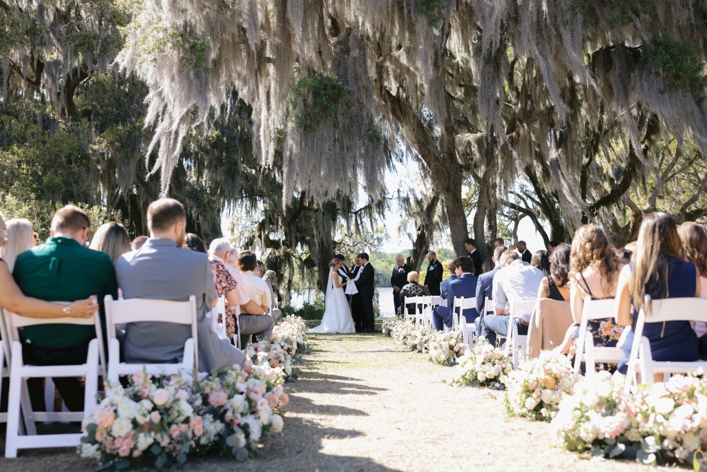 Low country lovely: Layered on top of the charming Wachesaw Plantation backdrop were Mariah&#039;s color palette picks of Southern peach, blushes, ivory, and sage greens throughout her florals and fashion.