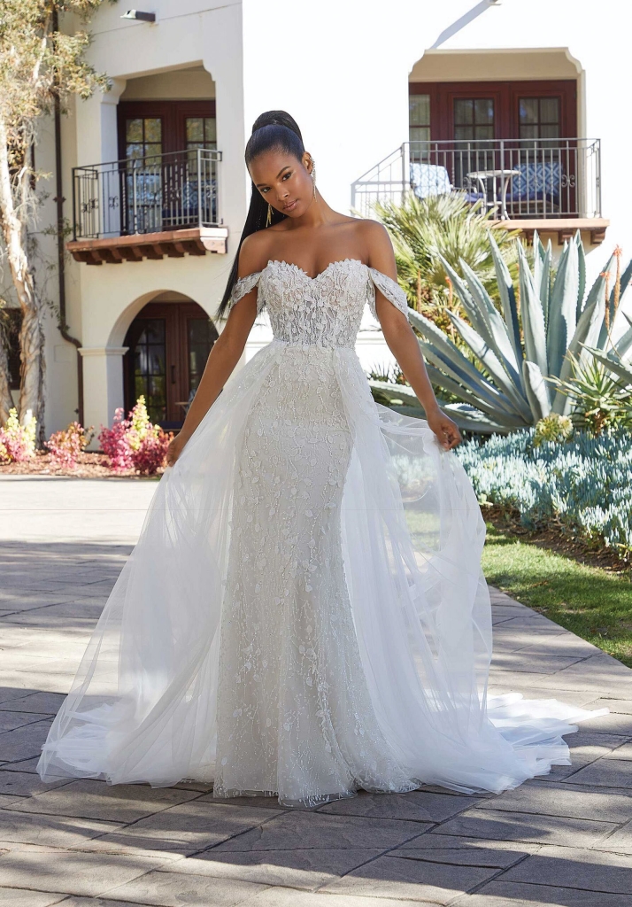Mori Lee Bridal The Misty Wedding Dress by Mori Lee Bridal has a fairytale-inspired fit and flare has crystal beading and playful 3D petals on sparkling glitter tulle. Styled with our crystal petal overskirt sold separately.. The Foxy Lady, $1,748