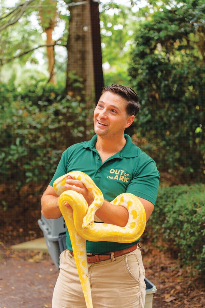 10:13am: Ryan with Sunny the albino Burmese Python. Photo by Jarod Castro.