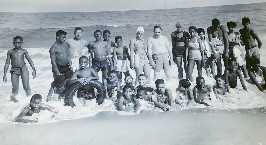 Counselors and campers from nearby Camp Baskerville of Holy Cross Faith Memorial Episcopal Church visiting McKenzie Beach in 1950.Walter Manigault Jr. is pictured third from the right in the bottom row.