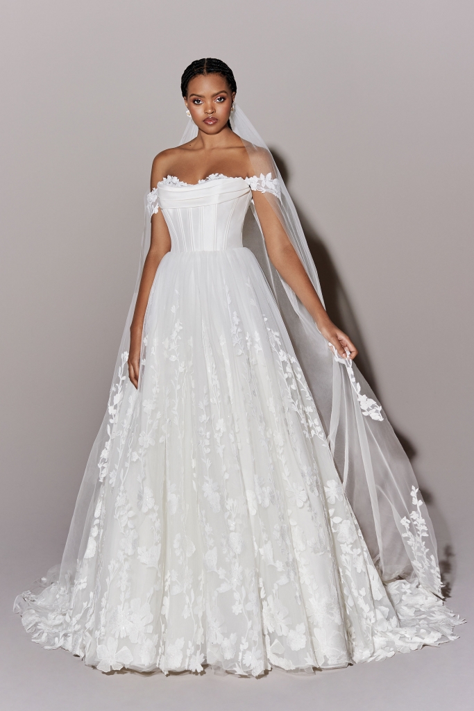 Justin Alexander Signature Pledge by Justin Alexander Signature, off-the-shoulder tulle ball gown with sequined lace appliques under a pleated Mikado scoop neckline with exposed boning. The Little White Dress Bridal Boutique, $3,199