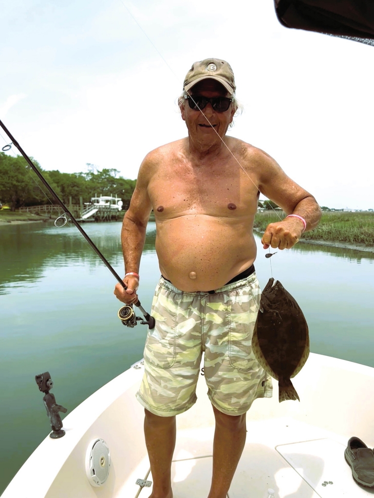 2:41pm: Lewis Huskey proudly shows off his catch, a flounder of around 17 inches, a &quot;keeper&quot;