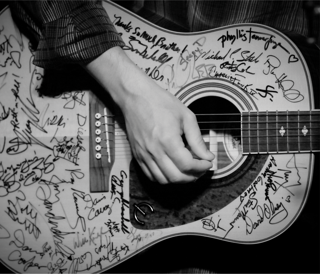 Lousiana songwriter Kevin Gordon performs with the “SXSE Guitar” on August 14, 2010. The guitar has been signed by many of the musicians that have performed at the series.