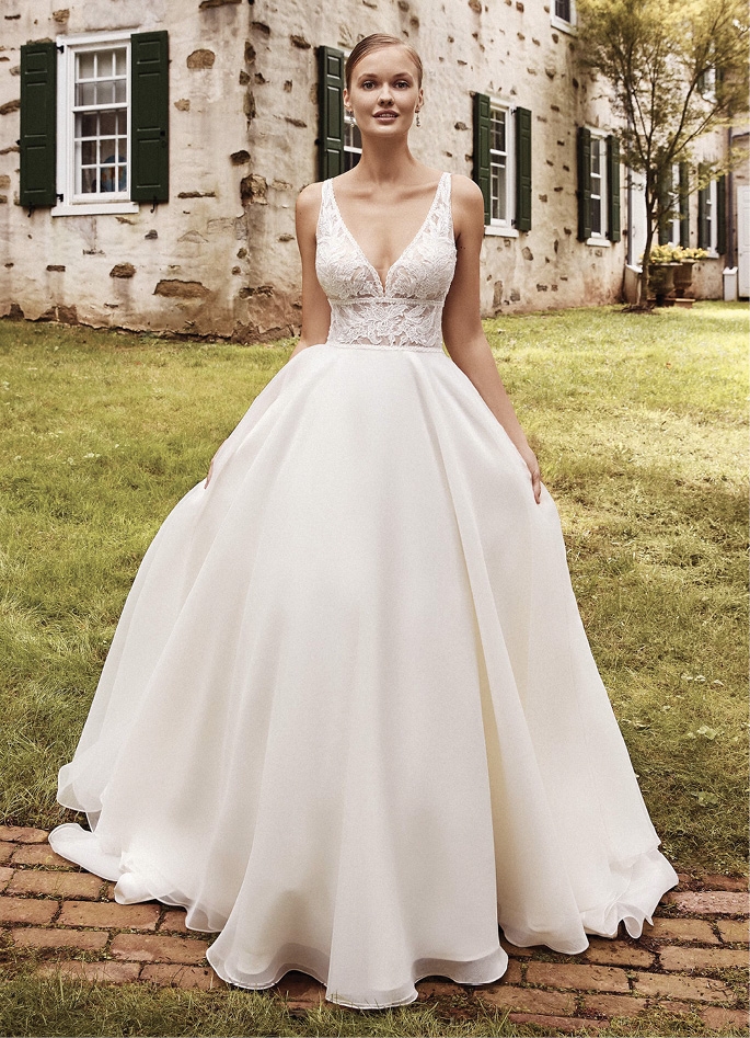 SINCERITY BY JUSTIN ALEXANDER - This enchanting ball gown will leave an impression. The sheer bodice features a deep V-neck accented with a waist defining cummerbund and an open V-back. It’s adorned with lightly sequined appliqués over top a Chantilly lace underlay. For more structure, this style is available with the bodice lined to the back.Fancy Frocks; price available upon request