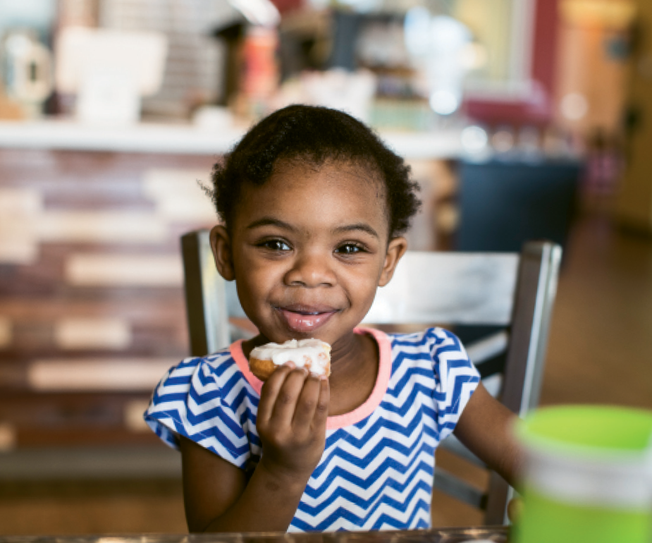 Two-year-old Kaiya Ramsay of Myrtle Beach enjoys a donut at Peace Love and Little Donuts.