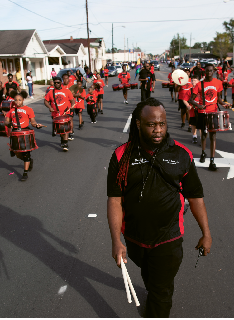 Founder Steven J. Grant watches over the members during a performance at the Andrews Homecoming Parade in downtown Andrews.