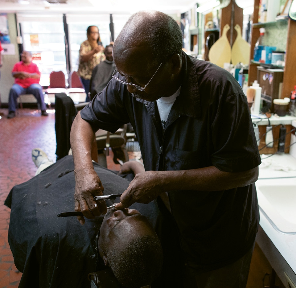 James Lewis, 61, has been coming to Franklin Tucker’s chair for at least 55 years. After Tucker cut his hair, he trimmed his mustache.