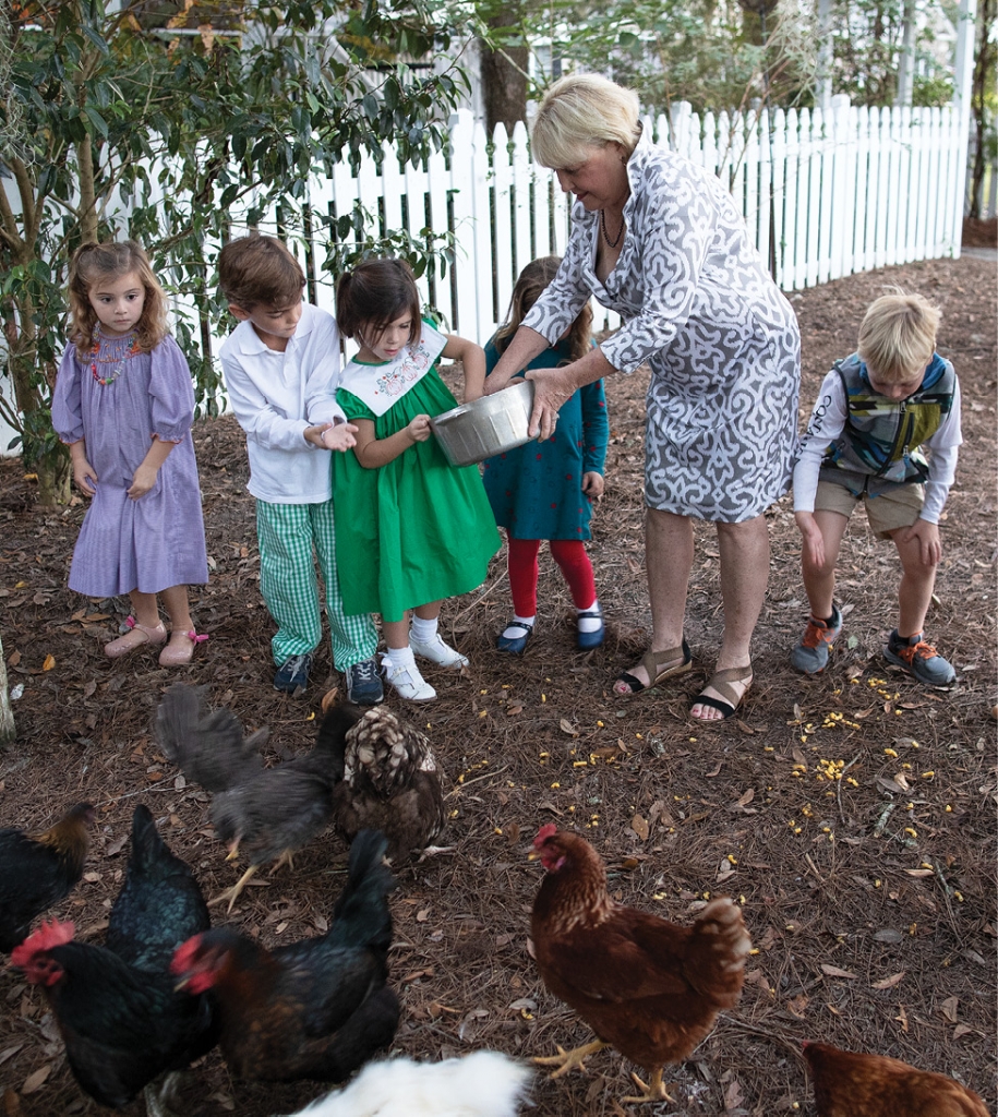 Ms. Flo gets help feeding her chickens from manners camp members