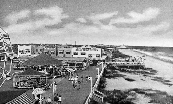 Circa 1938: A view of the Myrtle Beach boardwalk at Ninth Ave North. The humble beginnings of the Myrtle Beach Pavilion amusement park may be seen as well as the Ocean Front Tavern, still there today and now known as the Oceanfront Bar &amp; Grill.