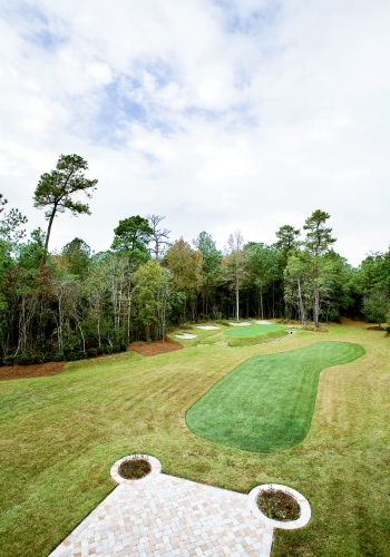 The backyard features a replica of the 13th hole at Augusta National Golf Club.